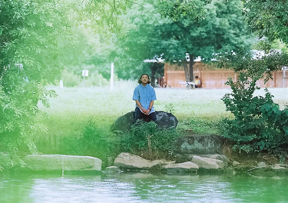in the blue shirt